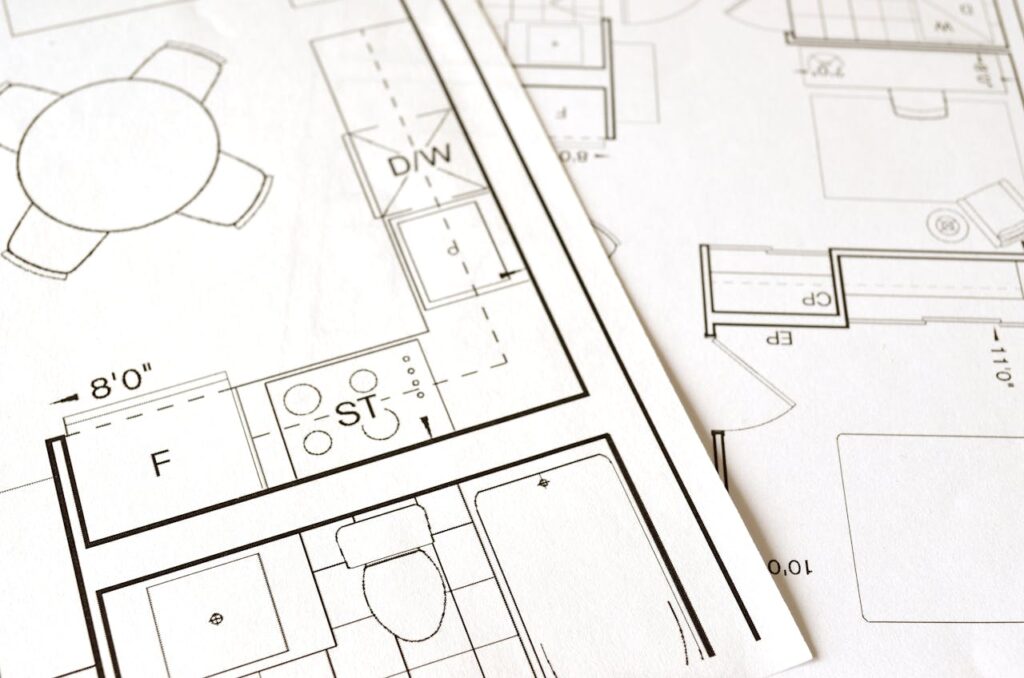 The Art of Drawing Readers In: Your attractive post title goes here Close-up view of an architectural floor plan on paper showcasing detailed room layouts and measurements.